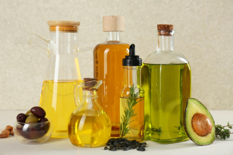 A collection of bottles containing various types of cooking oils.