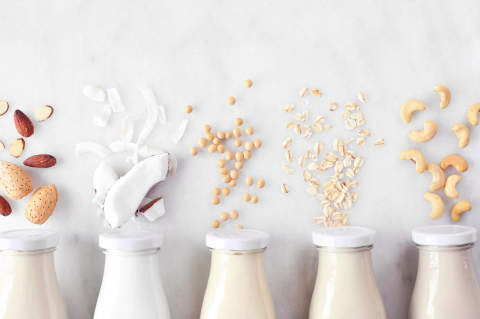 Variety of plant-based milks - almond milk, coconut milk, soy milk, and others.